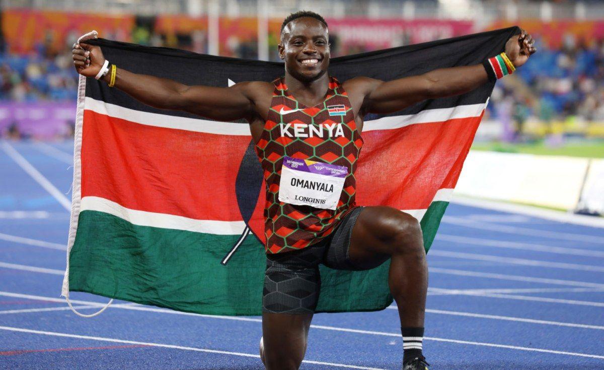 Omanyala Holding a kenyan flag