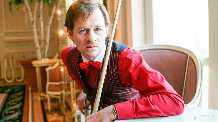 Alex Higgins with a cue stick