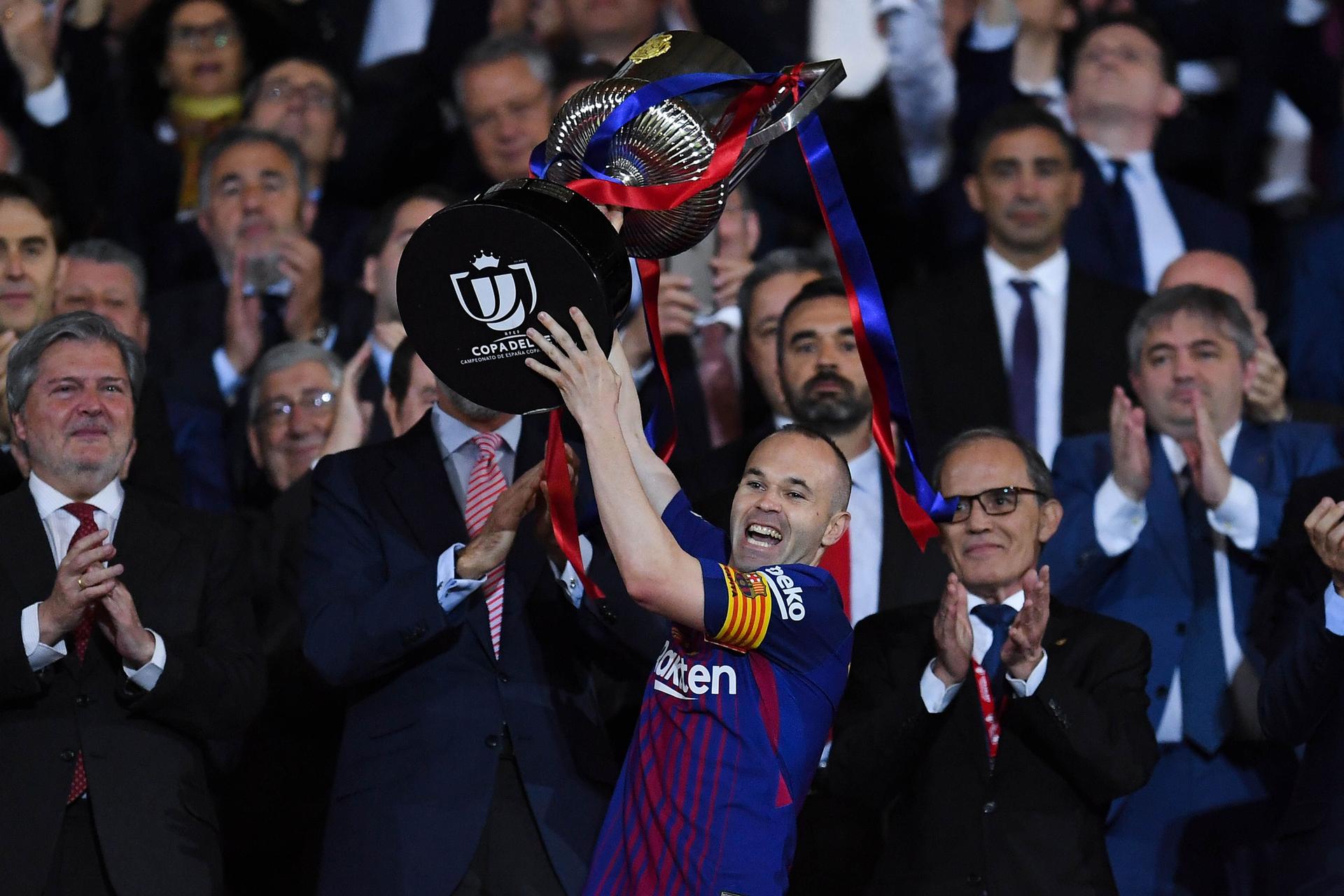 Andres Iniesta of FC Barcelona lifts the trophy 