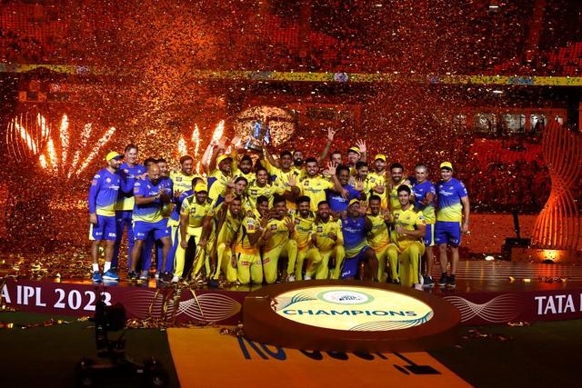 Players of Chennai Super Kings celebrate with the trophy after their victory against the Gujarat Titans in the Indian Premier League (IPL) Twenty20