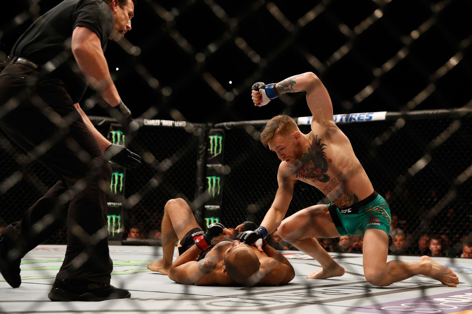 Conor McGregor punches Jose Aldo