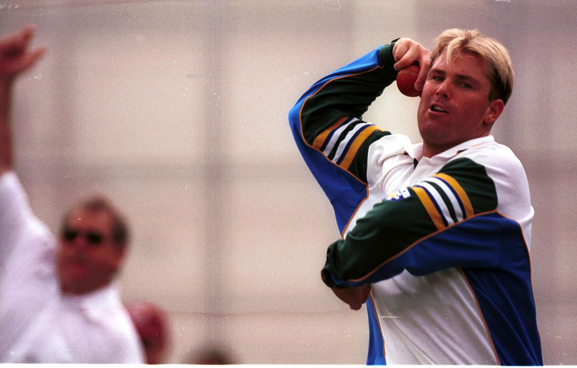 eg spin bowler Shane Warne of Australia bowls