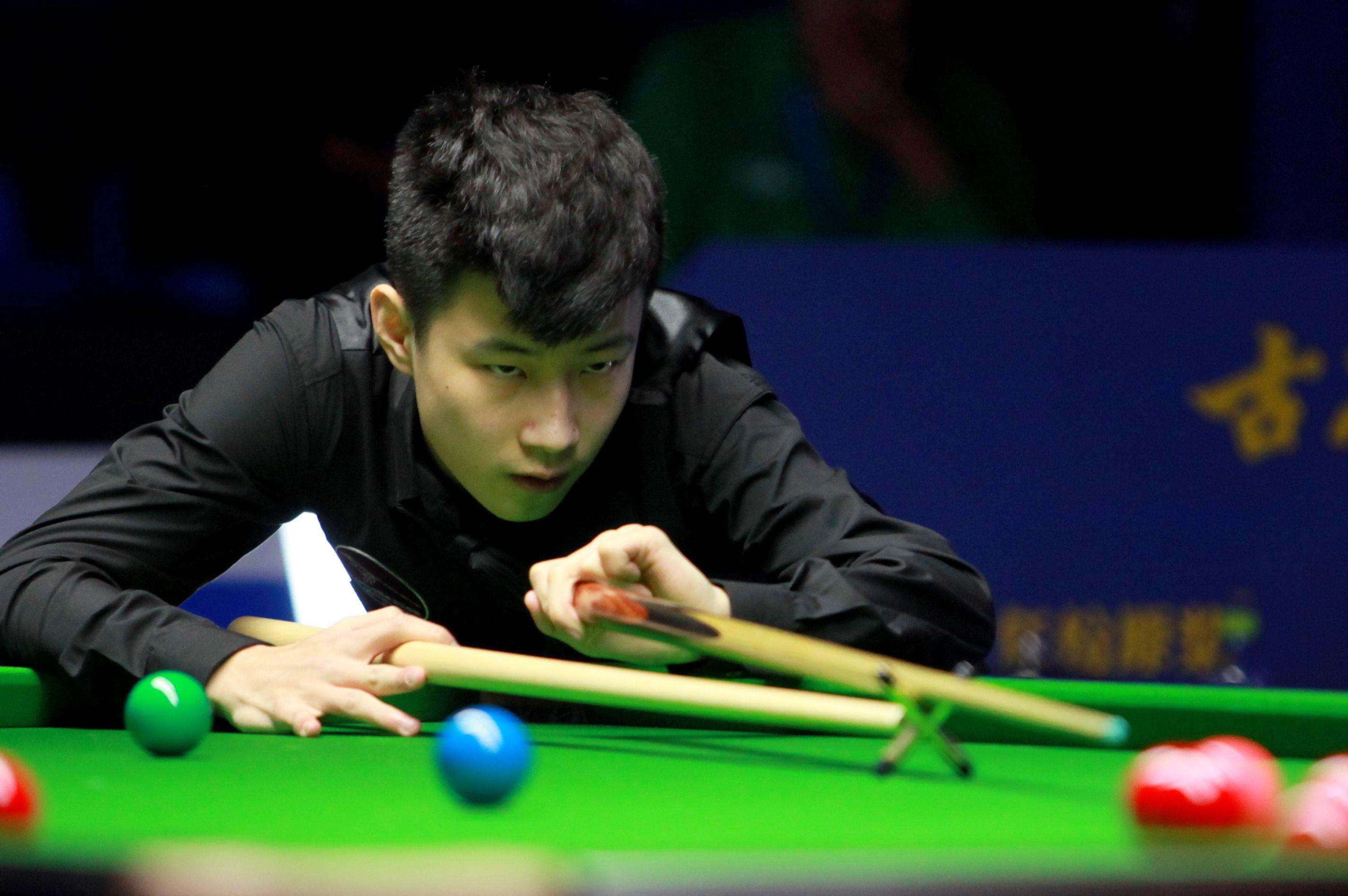 Zhao Xintong of China reacts against Rory McLeod