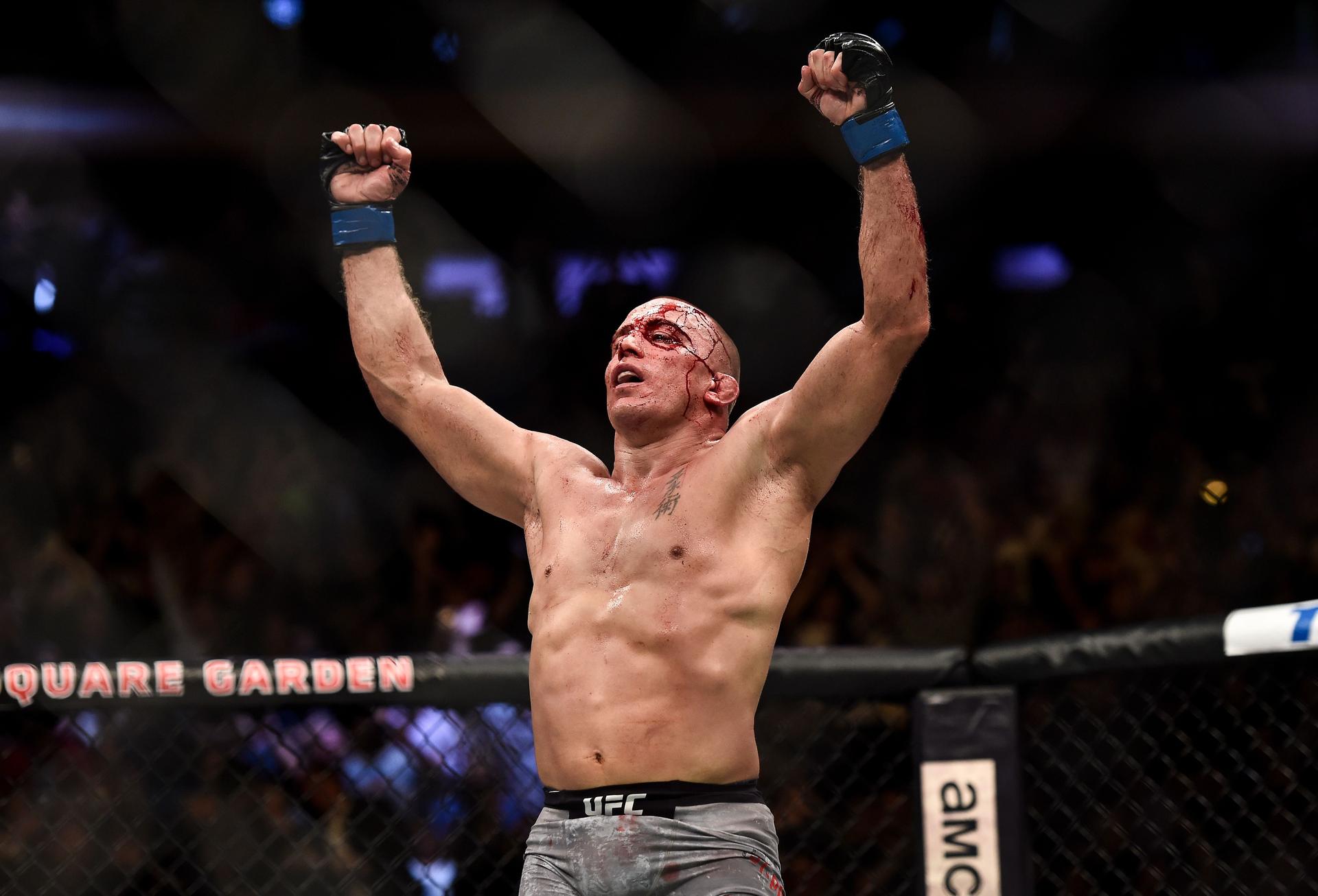  Georges St-Pierre of Canada celebrates his submission victory over Michael Bisping 