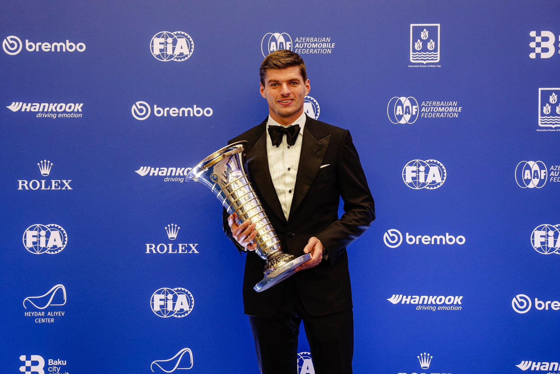 Max Verstappen with 2023 F1 Trophy.jpeg