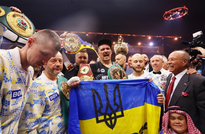 Oleksandr Usyk holds Ukrainian flag