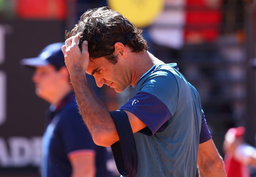 Roger Federer of Switzerland takes his head band off