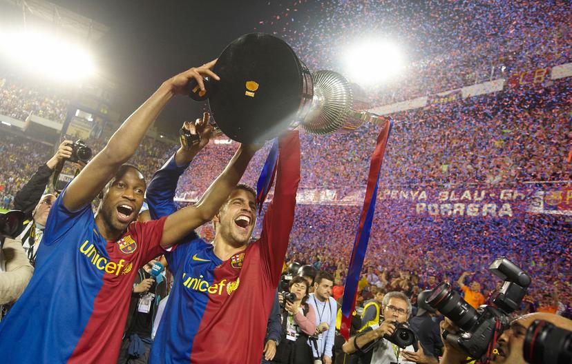 Seydou Keita of Barcelona celebrates with team mate Gerad Pique 