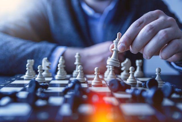 A chess board and a man playing chess 